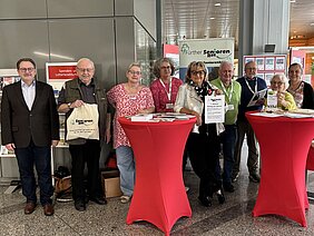 Mitglieder des Seniorenrates vor einem Infostand zum Welttag der älteren Menschen